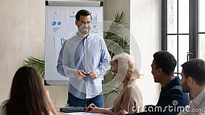 Laughing handsome businessman flip charts presentation new project in boardroom. Stock Photo