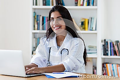 Laughing hispanic female general practitioner Stock Photo