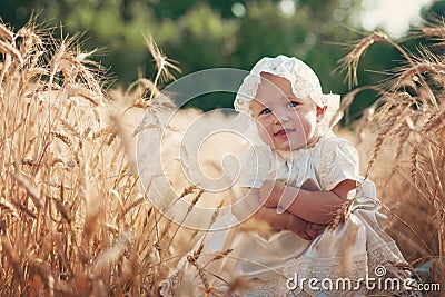 Laughing kid in sunny wheat field Stock Photo