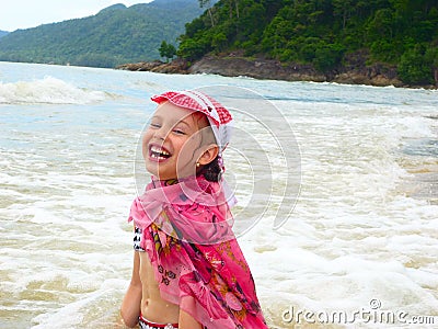 Laughing Little Girl on the Beach Stock Photo