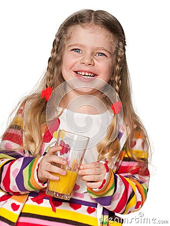 Laughing little girl with a glass of orange juice Stock Photo