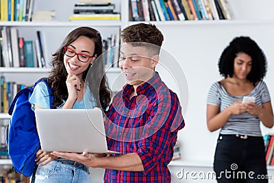 Laughing male student with nerdy girl at computer Stock Photo