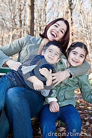 Laughing Mother Hugging Her Children Stock Photo