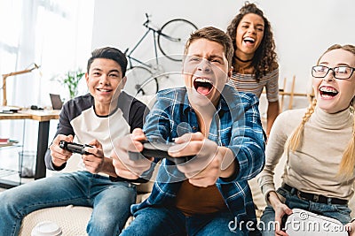 laughing multicultural teens playing Stock Photo