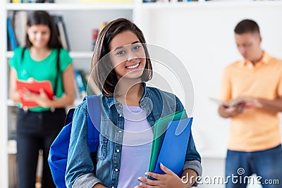 Laughing spanish female student with group of students Stock Photo