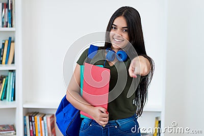 Laughing spanish female student with long hair Stock Photo