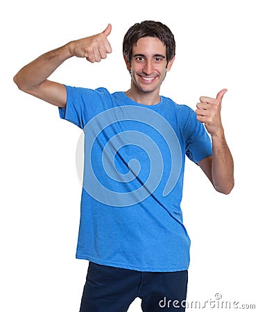 Laughing spanish guy in a blue shirt showing both thumbs up Stock Photo