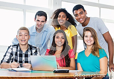 Laughing teacher with multicultural group of students Stock Photo