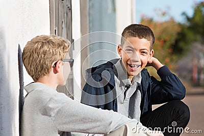 Laughing teen with braces outside with friend Stock Photo