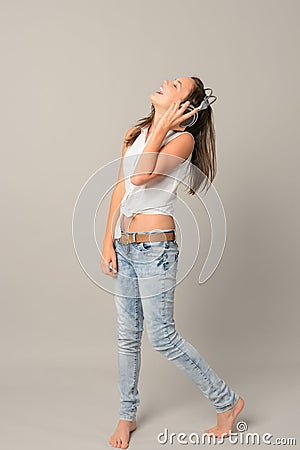 Laughing teenage girl enjoy music from headphones Stock Photo