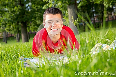 Laughing teenage summer lies in the grass Stock Photo