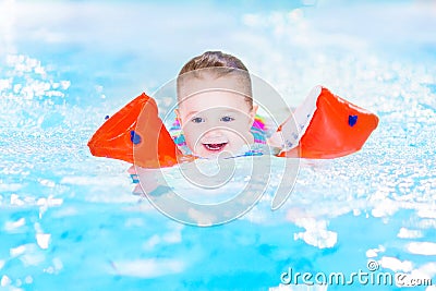 Laughing toddler girl having fun in swimming pool Stock Photo