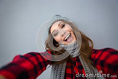 Laughing woman in hat and scarf making selfie photo Stock Photo