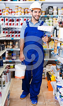 Workman choosing paint and brushes Stock Photo