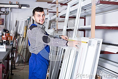 Laughing workman inspecting PVC manufacturing Stock Photo