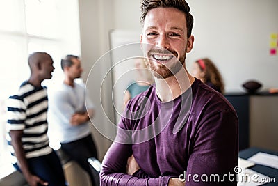 Laughing young designer standing in an office after a meeting Stock Photo