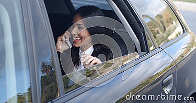Laughing young executive on phone in car Stock Photo