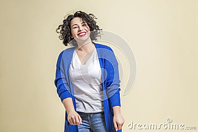 Laughing young woman. Beautiful bright curly brunette in jeans, a white T-shirt and a blue jacket. Positivity and happiness, Stock Photo