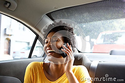 Laughing young woman in a car talking on mobile phone Stock Photo