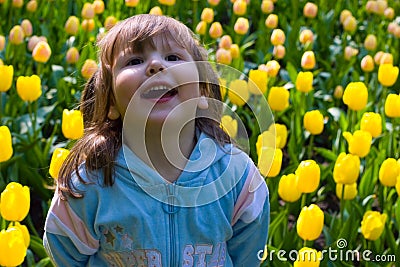 Laughting girl in tulips Stock Photo