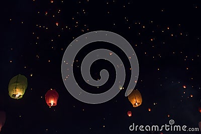 Swarms paper lanterns flying in the beautiful dark sky. Stock Photo