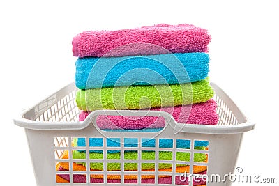 Laundry basket filled with colorful folded towels Stock Photo