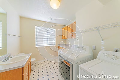 Laundry and bathroom combination interior with patterned tiles and shelving units Stock Photo