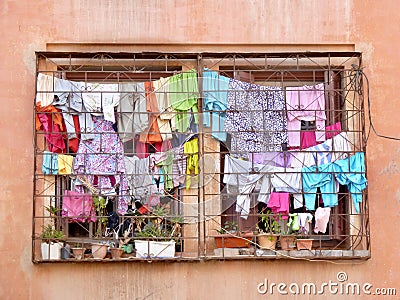 Laundry day in Marrakech, colorful clothes hanging outside the window. Morocco. Stock Photo