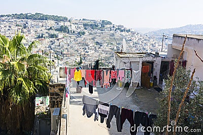 Laundry dries outdoor on a roof of house, located outside of Jerusalem Old City Walls. Panoramic city view. Israel. Stock Photo
