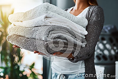 Laundry, hands and woman with towel stack for spring cleaning linen, fabric and textiles to clean in house work. Person Stock Photo