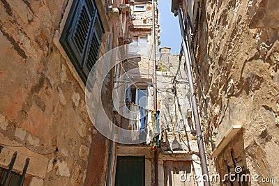 Laundry hans above street drying between apartments Stock Photo