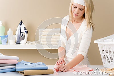 Laundry ironing - woman folding clothes Stock Photo