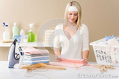 Laundry ironing - woman folding clothes Stock Photo