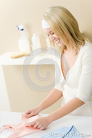 Laundry ironing - woman folding clothes Stock Photo