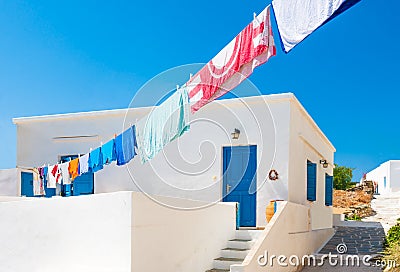 Laundry line outside Greek island house Stock Photo