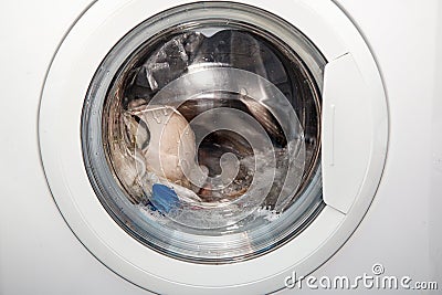 Laundry is washed in a washing machine Stock Photo