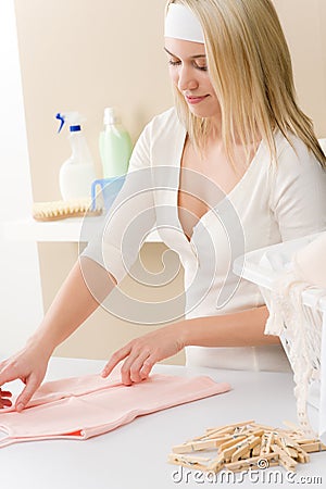 Laundry - woman folding clothes Stock Photo