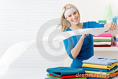 Laundry - woman folding clothes Stock Photo