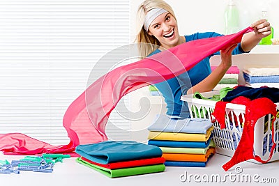 Laundry - woman folding clothes Stock Photo