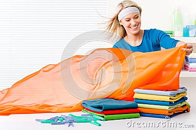 Laundry - woman folding clothes Stock Photo