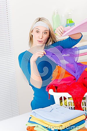 Laundry - woman folding clothes home Stock Photo