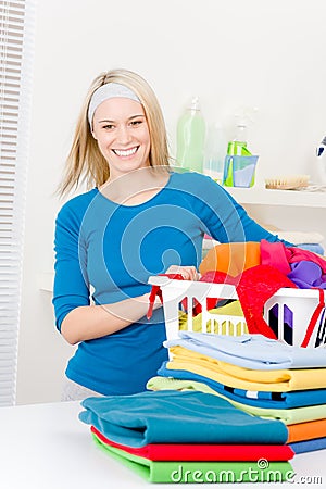 Laundry - woman folding clothes home Stock Photo