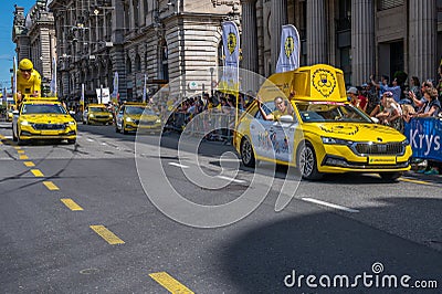 Lausanne, Vaud Canton, Switzerland -09.07.2022: Passage of an advertising car of yellow jersey LCL in the caravan of the Tour de Editorial Stock Photo