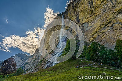 Lauterbrunnen waterfall dramatic sky pasture Stock Photo