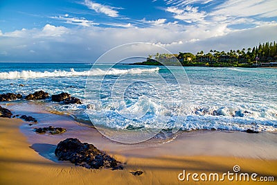 Lava rock, golden sand, white foam, napili bay, maui Stock Photo