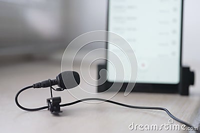 The lavalier microphone lies on a table Stock Photo