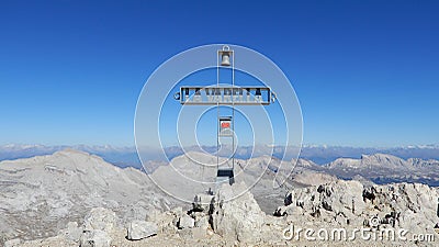 Mountain peak cross with blue sky in the background Stock Photo