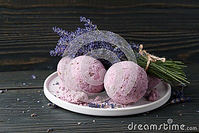 Lavender bath bombs and flowers on dark wooden table Stock Photo