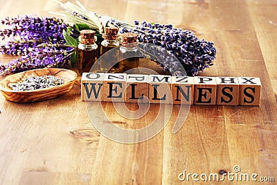 Lavender herbal oil and lavender flowers. bottle of lavender massage oil for aromatherapy treatment and wellness letters made of Stock Photo