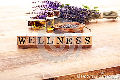 Lavender herbal oil and lavender flowers. bottle of lavender massage oil for aromatherapy treatment and wellness letters made of Stock Photo